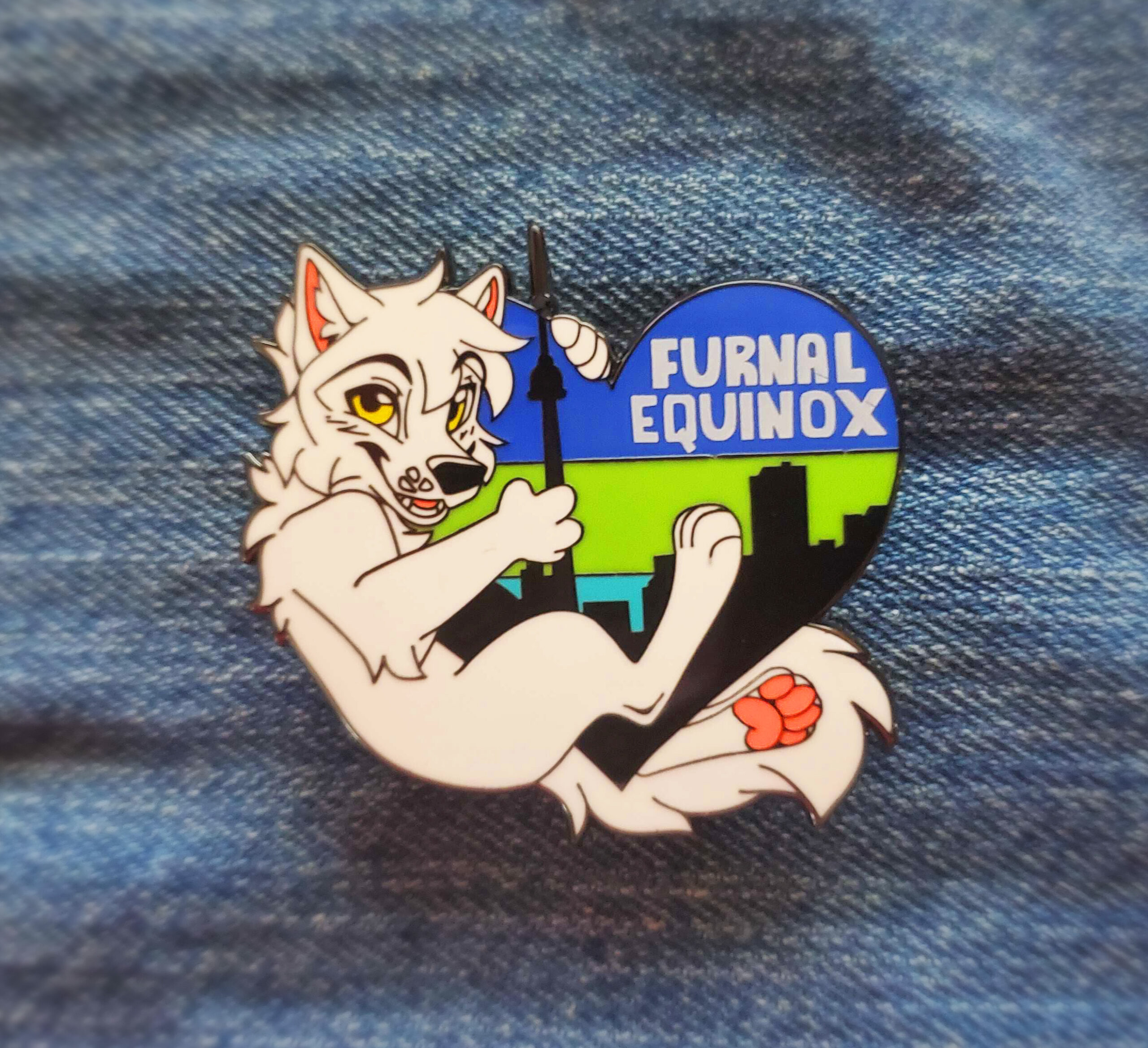 pin3 A close up of a hand holding the hard enamel pin. it's that features a lynx riding a skateboard with the inscription FE 2020.