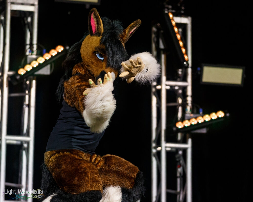 A photo of Dodge Horse, a costume performer, dancing on a stage.